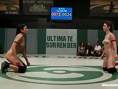 The match is intense and it appears to be that the referee is looking somewhere else cuz things are going wild in the arena. These bitches don't know the meaning of fair play and a cutie comes in the aid of the other one. Looks like someone will need to surrender
